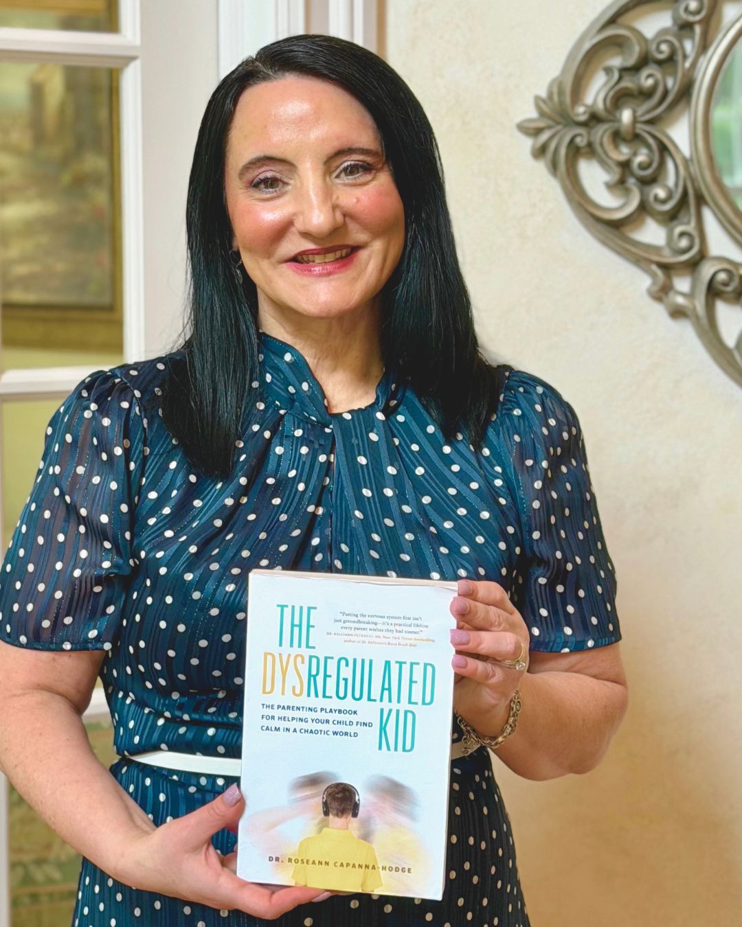 Dr. Roseann Capanna-Hodge holding The Dysregulated Kid
