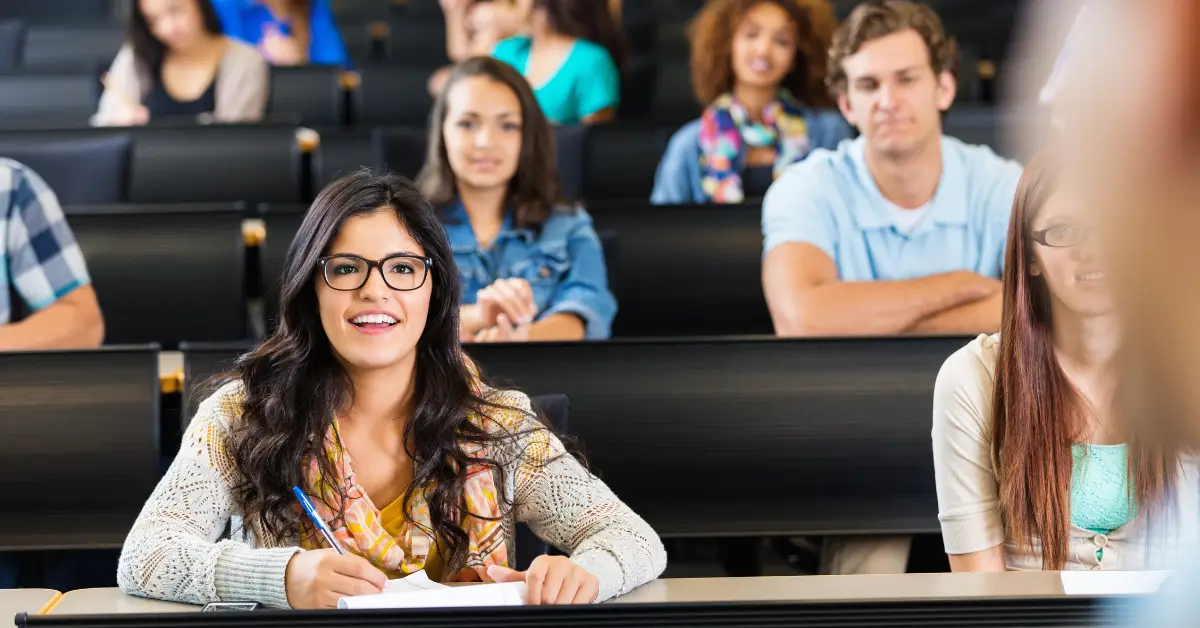 Female student taking notes during lecture class