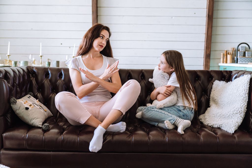 Woman talking with child on couch