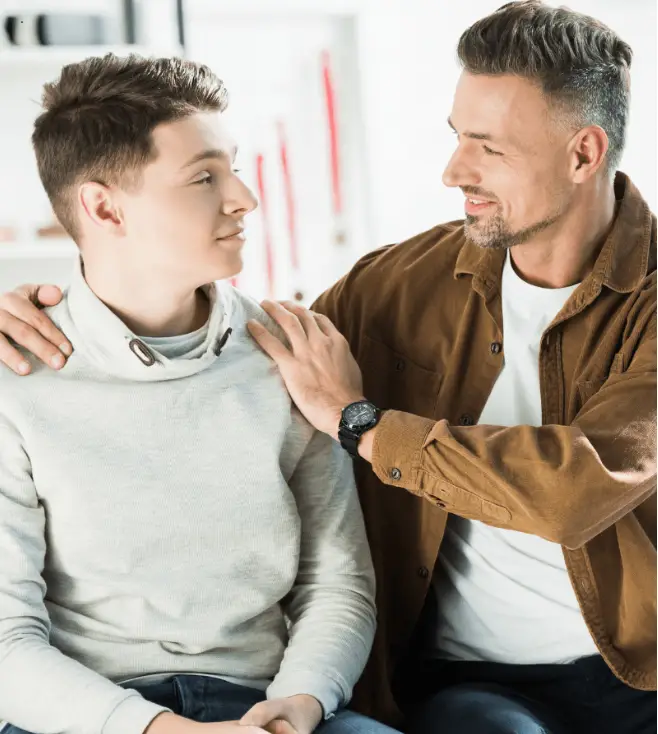 Father and young man having supportive conversation