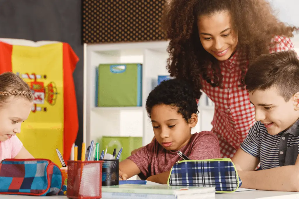 Teacher and children of various backgrounds working together at a table
