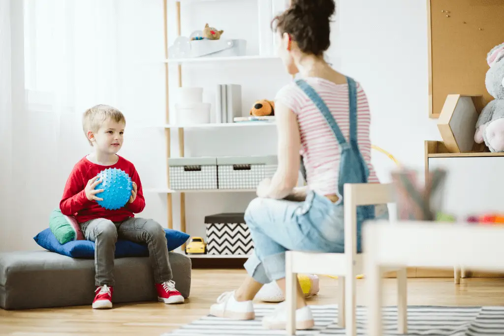 Parent talking calmly with child during a sensory regulation activity
