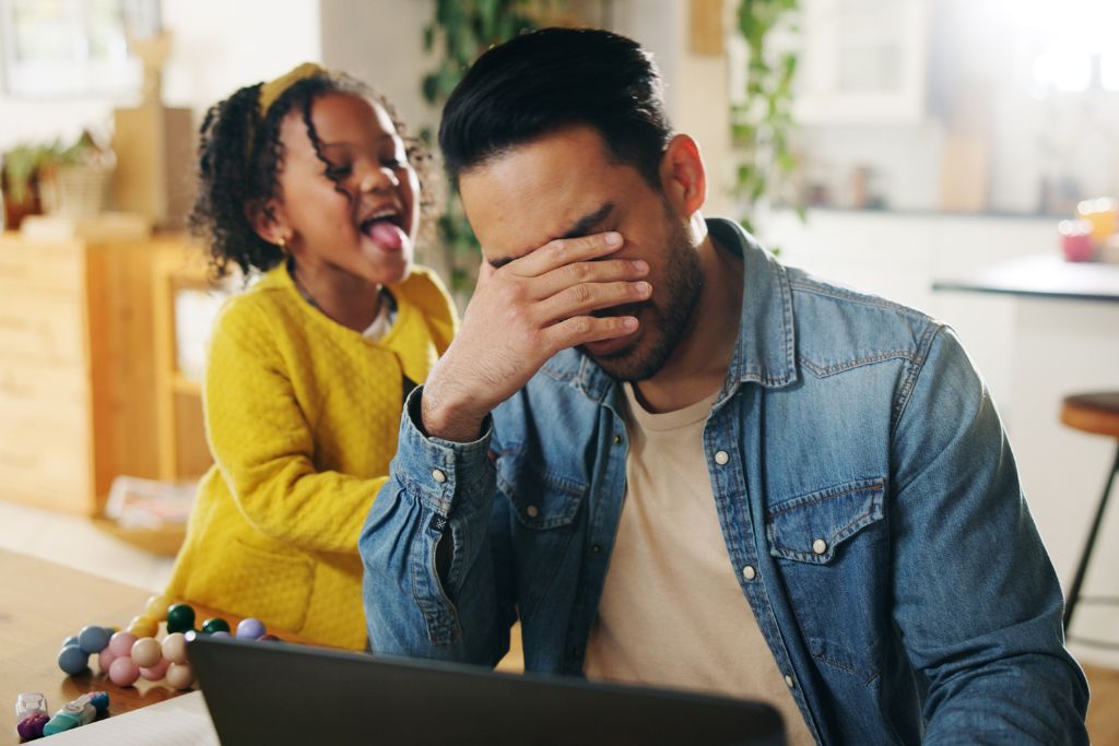 Father and child at table with frustrated expressions