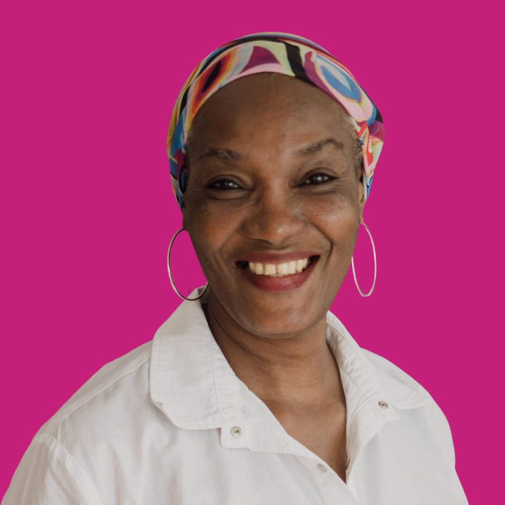 Woman smiling in professional headshot against magenta background