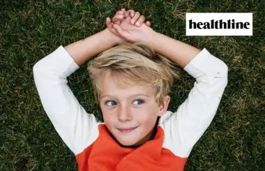 Child on grass featured in Healthline article on self-regulation skills