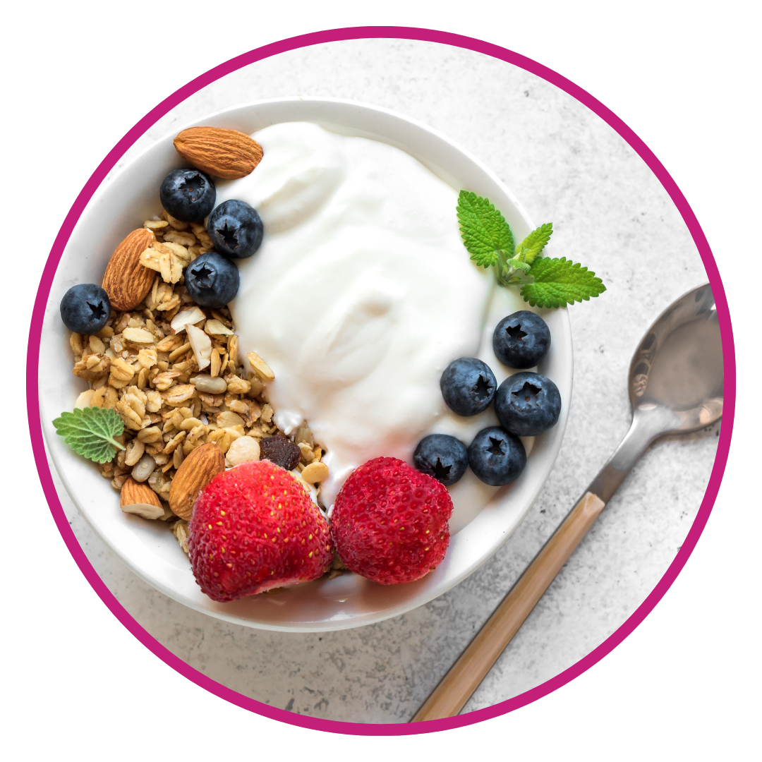 Yogurt bowl with granola, berries, and fresh mint leaves