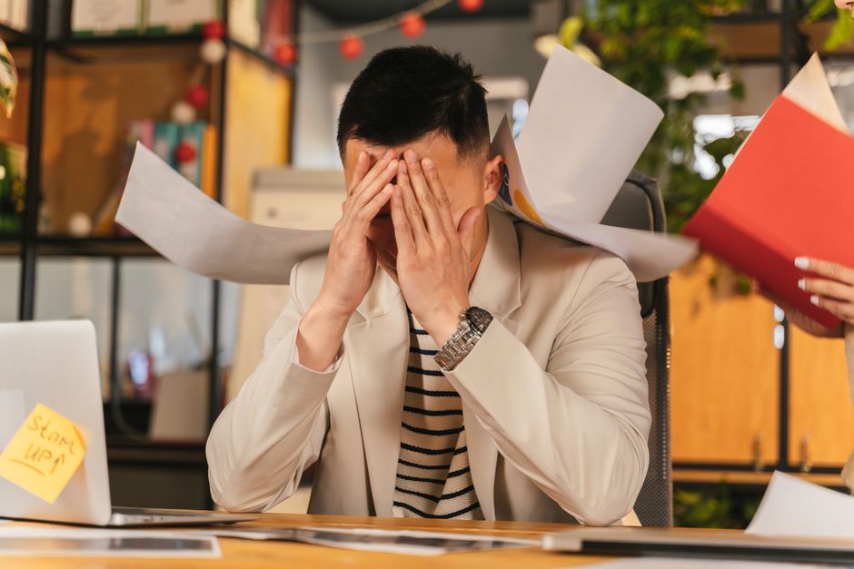 stressed adult at a work desk - adhd emotional dysregulation examples
