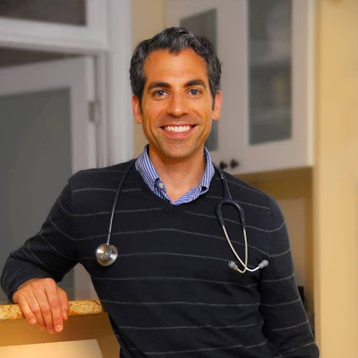 Male healthcare professional wearing stethoscope and striped shirt